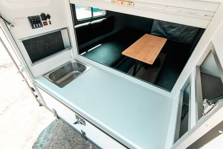 Photo a white kitchen in a mobile home with a sinkの写真素材