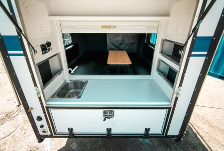 Photo a white kitchen in a mobile home with a sinkの写真素材