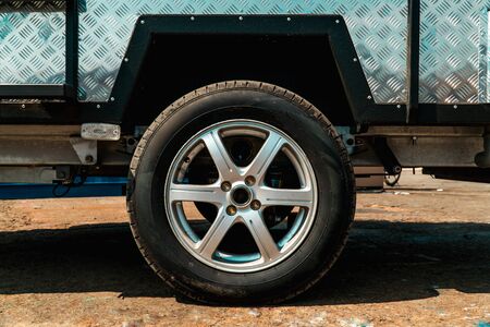 Photograph of truck with metal sides and wheels on cast discs close-upの写真素材