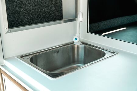 Photo a white kitchen in a mobile home with a sinkの写真素材
