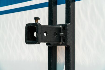 Photograph of a black metal structure for attachment to a white wallの写真素材