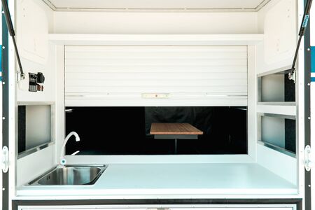 Photo a white kitchen in a mobile home with a sinkの写真素材