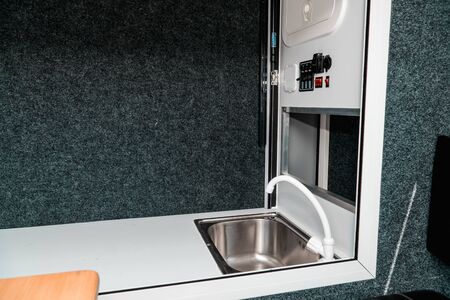 Photo a white kitchen in a mobile home with a sinkの写真素材