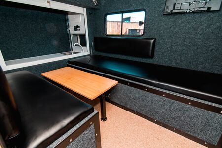 Photo of a small room with table, leather chairs and windowの写真素材