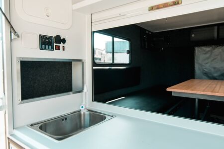 Photo a white kitchen in a mobile home with a sinkの写真素材