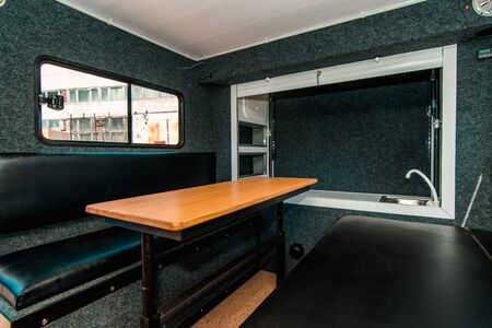 Photo of a small room with table, leather chairs and windowの写真素材