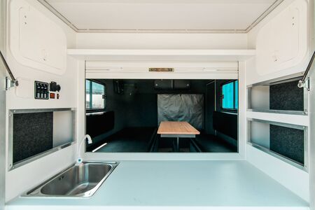Photo a white kitchen in a mobile home with a sinkの写真素材