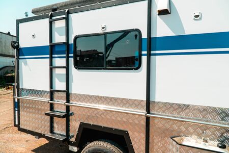 Photo of white makeshift house on wheels taken from trailerの写真素材