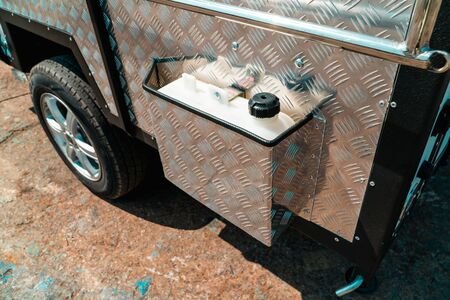 Photo of a van with metal coating and fixed conistrum with waterの写真素材