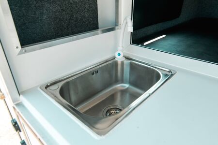 Photo a white kitchen in a mobile home with a sinkの写真素材