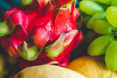 Photo of different bright multicolored tropical fruits and berries close-upの写真素材