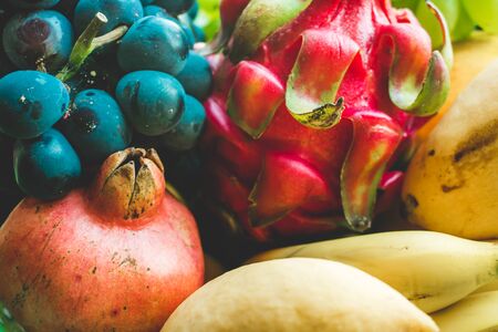 Photo of different bright multicolored tropical fruits and berries close-upの写真素材