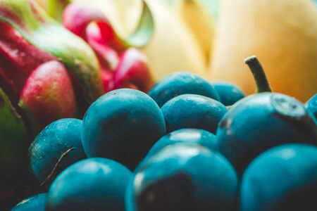 Photo of different bright multicolored tropical fruits and berries close-upの写真素材