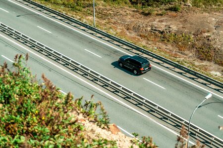 Photograph of coastal paved road by the sea with passing carsの写真素材