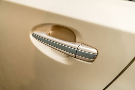 Photo of door chrome handle of car of gold color close-upの写真素材