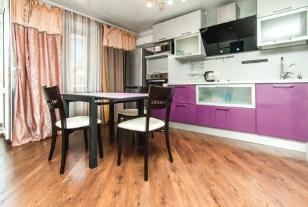 The photo of completely equipped light kitchen with household appliancesの写真素材