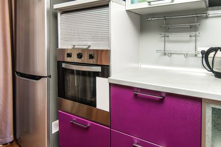 The photo of completely equipped light kitchen with household appliancesの写真素材