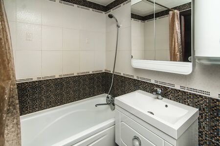 The photo of the light white bathroom with household appliancesの写真素材