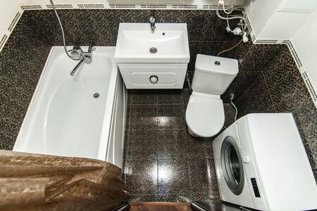 The photo of the light white bathroom with household appliancesの写真素材