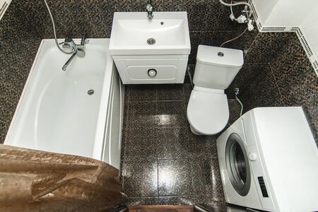 The photo of the light white bathroom with household appliancesの写真素材