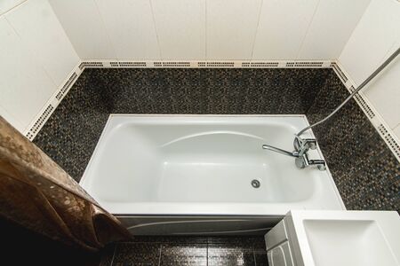 The photo of the light white bathroom with household appliances