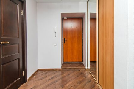 The photo of the hall of the room with an entrance and a mirror caseの写真素材