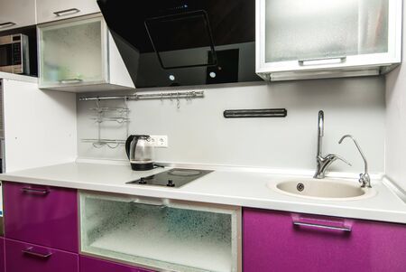 The photo of completely equipped light kitchen with household appliancesの写真素材