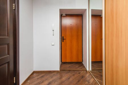 The photo of the hall of the room with an entrance and a mirror caseの写真素材