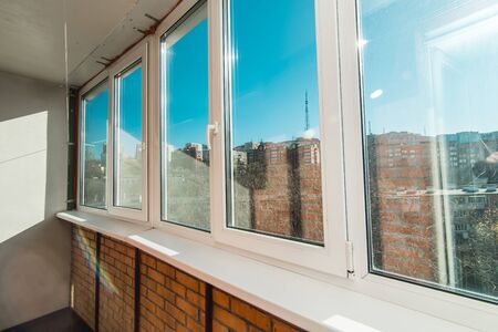 The photo of a light balcony with a view from the windowの写真素材