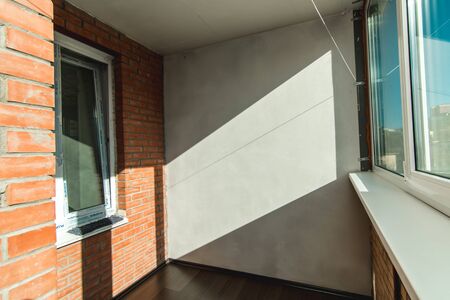 The photo of a light balcony with a view from the windowの写真素材