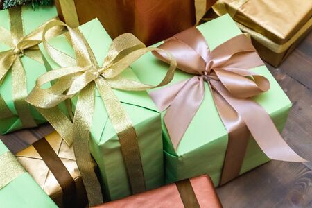 Decorated boxes with New Year gifts tied with ribbons lying under the tree.の写真素材