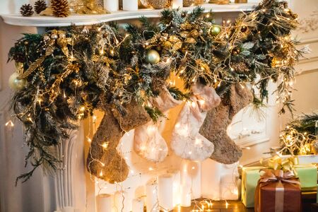 Photo of a New Year decorated fireplace with weighing socks for giftsの写真素材