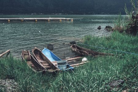 Photograph of old fisherman boats standing on the bank by the riverの写真素材