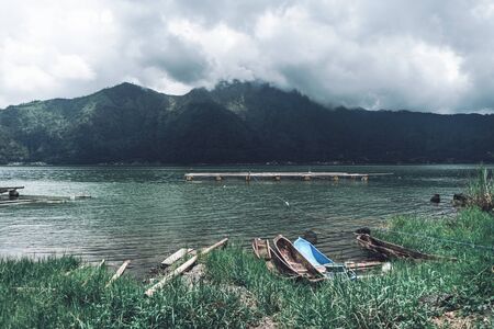 Photograph of old fisherman boats standing on the bank by the riverの写真素材