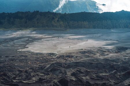 Photograph of rocks with volcanic rock and sand dune on background on Java island in Indonesiaの写真素材