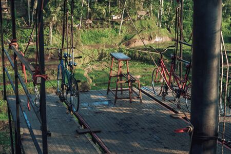 Photo of a structure for cycling a tightrope between two mountains in a rice fieldの写真素材