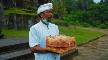 Pampatan, Rendang, Karangasem Regancy, Bali, Indonesia - July 18, 2020: Hindu priest wearing a white uniform was carrying out a religious ceremonyのeditorial素材
