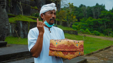 Pampatan, Rendang, Karangasem Regancy, Bali, Indonesia - July 18, 2020: Hindu priest wearing a white uniform was carrying out a religious ceremonyのeditorial素材