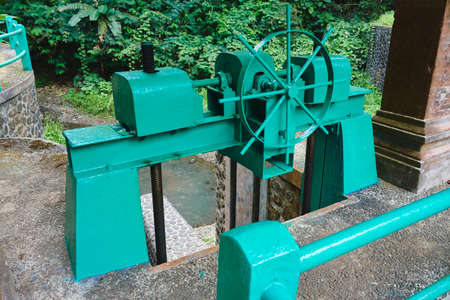 Photo of an old water dam for water supply to rice fields in Indonesia with water tapの写真素材