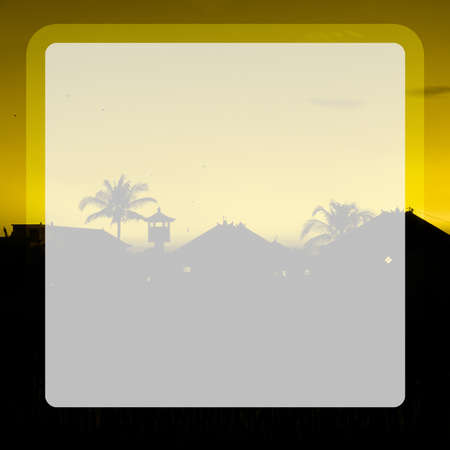 Photo of tall palm trees against a yellow sky with a long wooden trunk in a transparent windowの写真素材