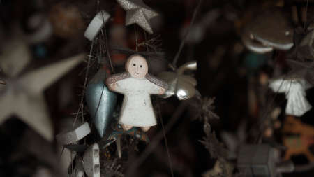 Small Christmas wooden colors toys of angel hanging in the houseの写真素材