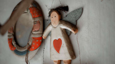 Small Christmas wooden colors toys of angel hanging in the house
