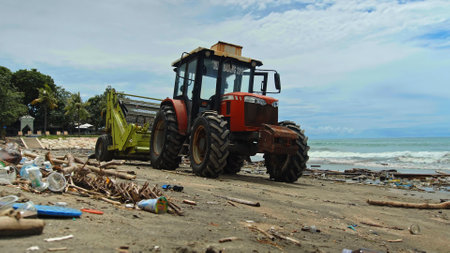 Kuta, Badung, Bali, Kuta Beach Indonesia - 4, January 2021: Tractor technic for cleaning the sea beach from garbage stands on the sand after throwing plastic garbage from the sea on the island of Bali in the city of Kutaのeditorial素材