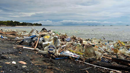 Beach pollution. 4K video of plastic garbage and other trash on sea beach. Ecological concept