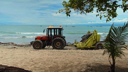 Kuta, Badung, Bali, Kuta Beach Indonesia - 4, January 2021: Tractor technic for cleaning the sea beach from garbage stands on the sand after throwing plastic garbage from the sea on the island of Bali in the city of Kutaのeditorial素材