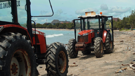 Kuta, Badung, Bali, Kuta Beach Indonesia - 4, January 2021: Tractor technic for cleaning the sea beach from garbage stands on the sand after throwing plastic garbage from the sea on the island of Bali in the city of Kutaのeditorial素材