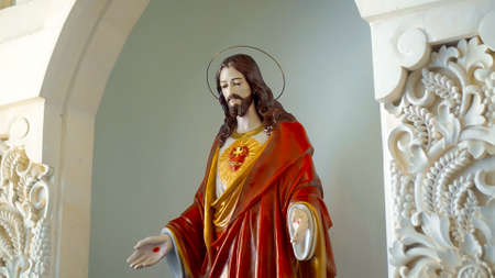 Statue of Jesus in the church stay near the wallの写真素材