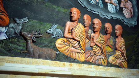 Kintamali, Bali, Indonesia - 05, July 2022: A painting on a wall in a Buddhist temple with a buddha and the history of his arrival and lifeのeditorial素材