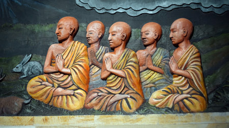 Kintamali, Bali, Indonesia - 05, July 2022: A painting on a wall in a Buddhist temple with a buddha and the history of his arrival and lifeのeditorial素材