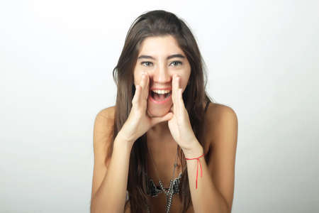 Portrait of young attractive woman  in swimsuit screaming.の写真素材